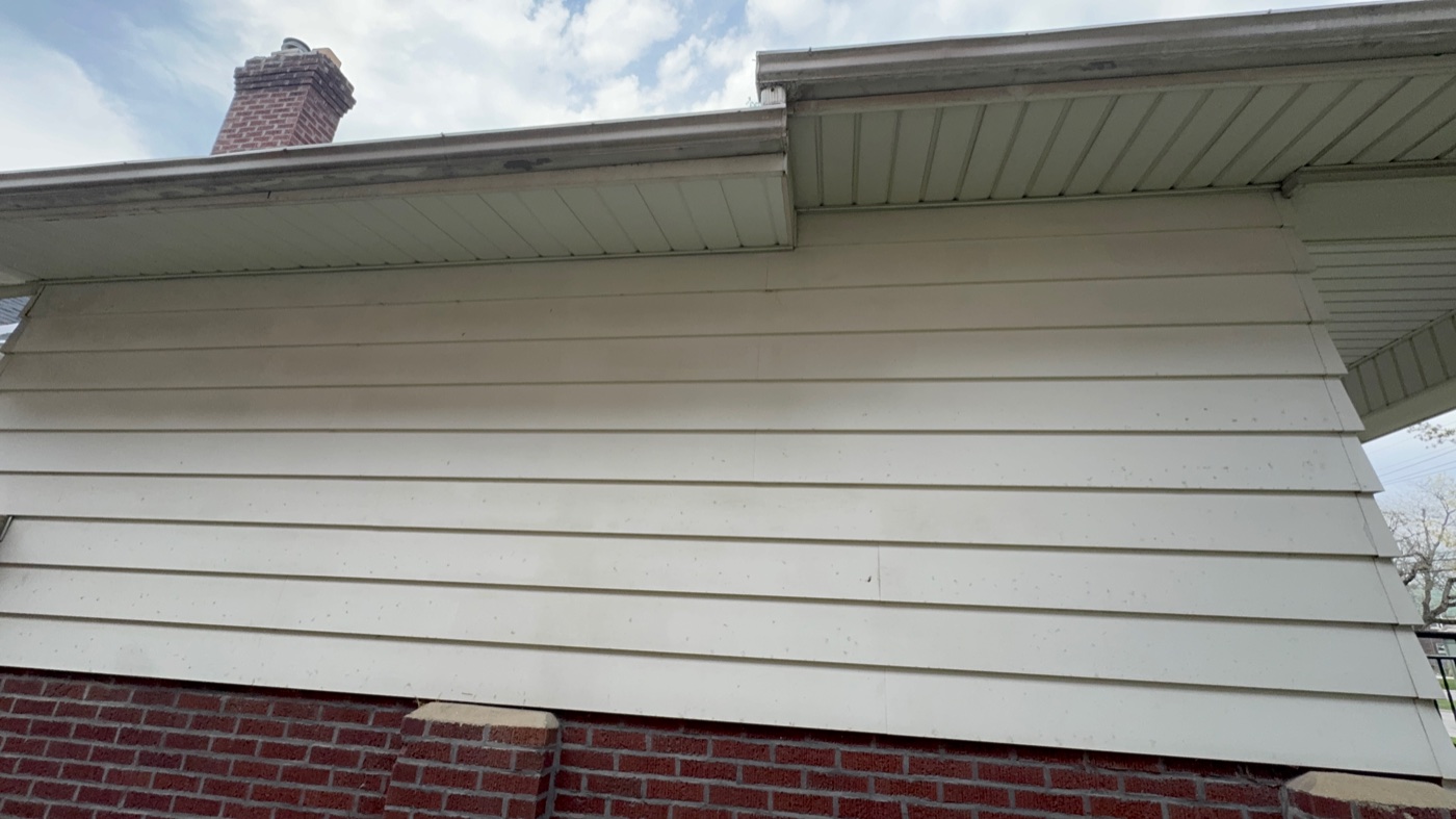 Brightened gutter fascia after Pinnacle Wash cleaning on a tree-lined Gahanna home
